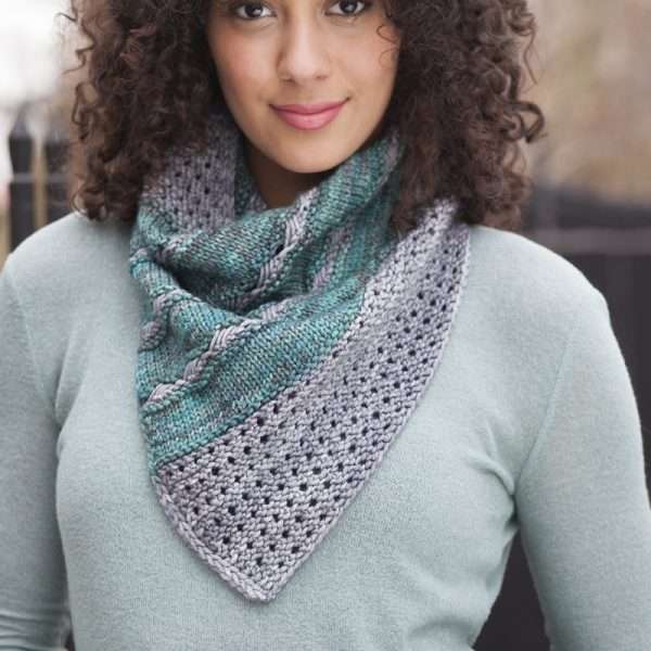 Woman wearing a scarf made from Malabrigo Rios yarn